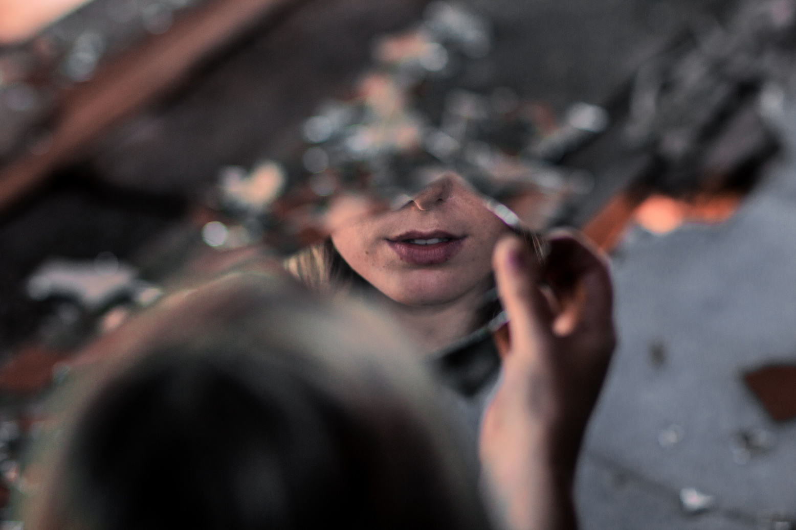 Woman Looking Through Broken Mirror