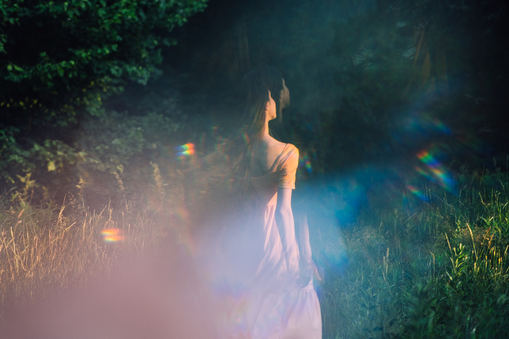 Moments of stillness. moments of self-care and self-soothing. Healing rituals and meditation. Dance Movement . Young woman dancing in nature background with reflection